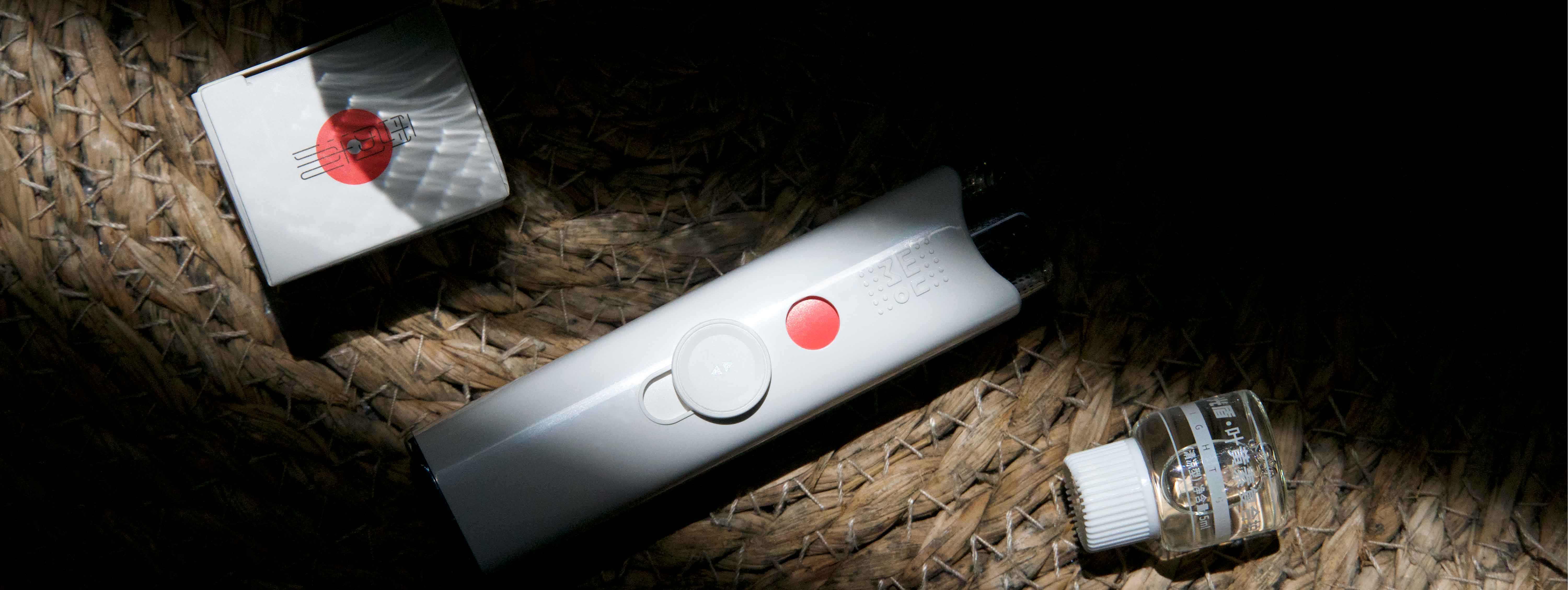 A stylish flat-lay image showing a Wumo Eye Mister alongside a smartwatch, wireless earbuds, and a smartphone with a meditation app open
